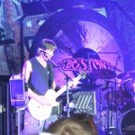 Guitarist, keyboardist, songwriter and producer Tom Scholz with the band, Boston playing at the Buffalo Chip campground.